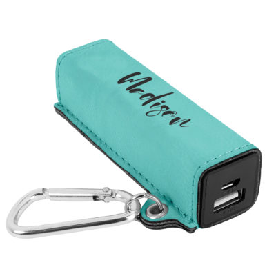 power bank on top of black table next to smartphone